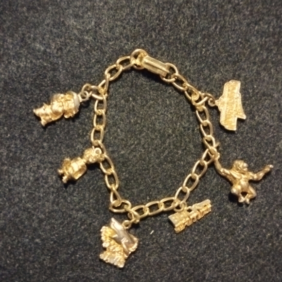 Universal Jewelry - Vintage 1980's Universal Studios gold tone charm Bracelet with 6 charms